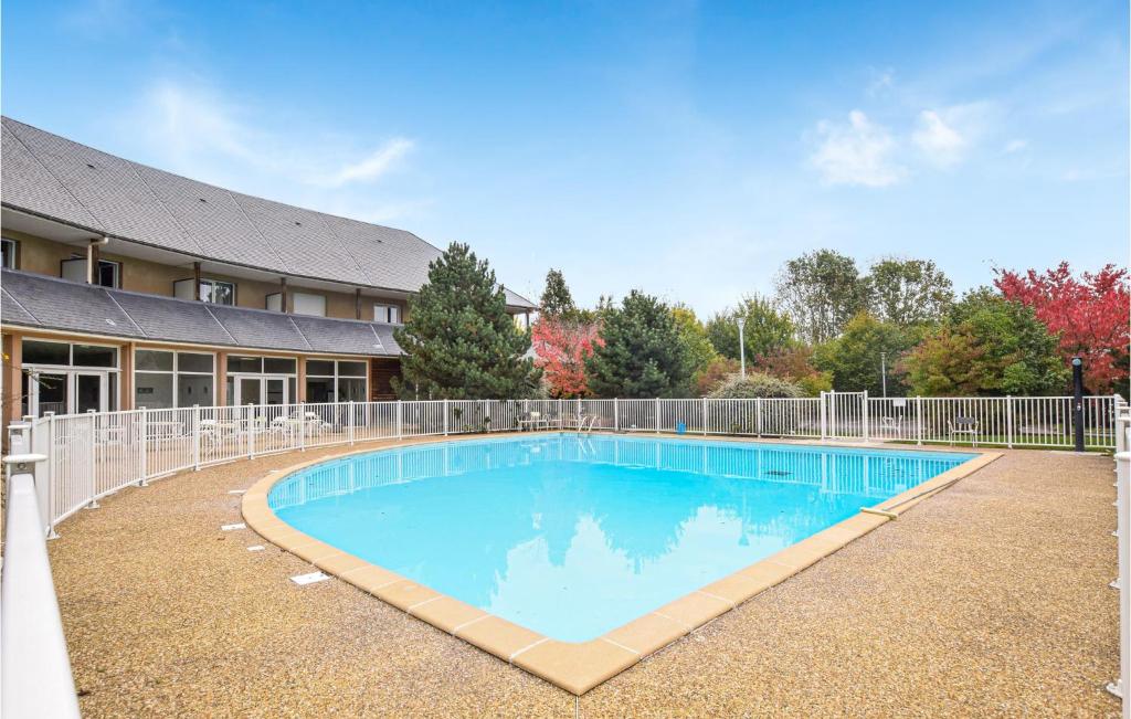 una gran piscina frente a un edificio en Lovely Apartment In quemauville With Heated Swimming Pool, en Équemauville
