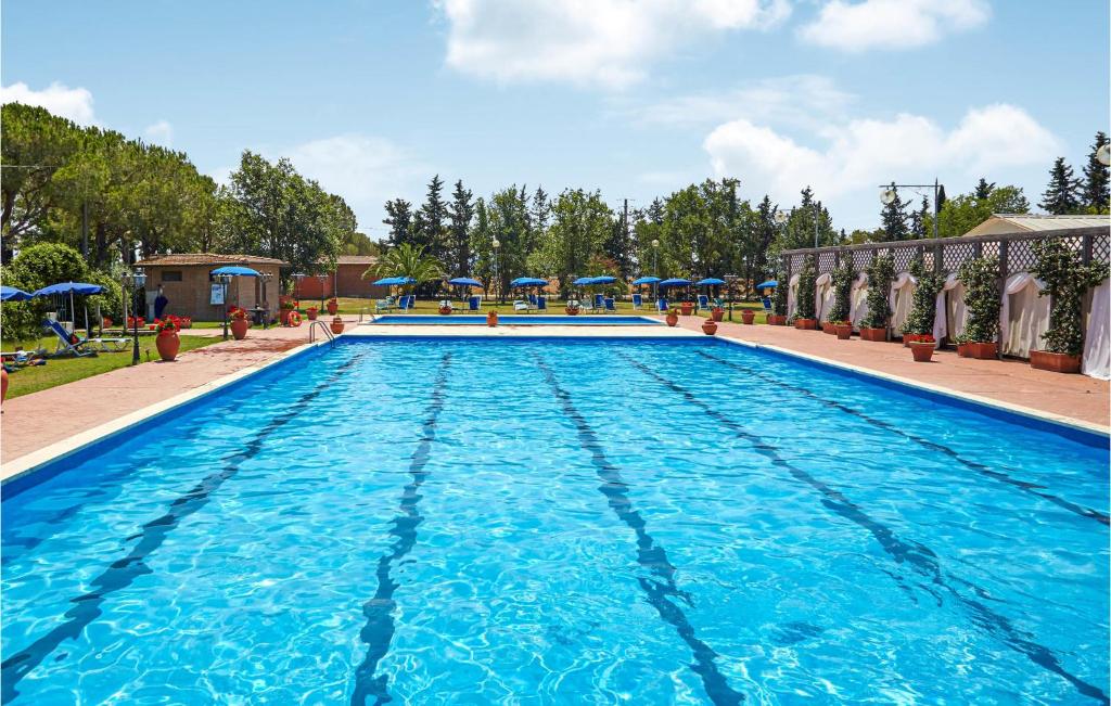 a large swimming pool with blue water at Apt B5 in Grosseto
