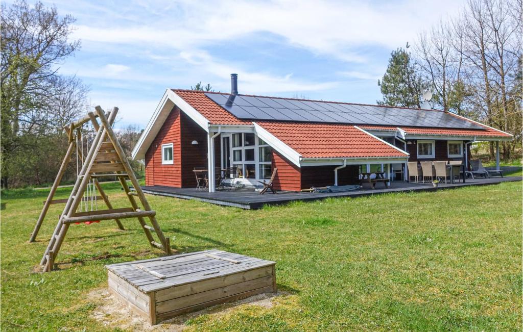a house with a ladder and a playground in front of it at Stunning Home In Aakirkeby With Wifi in Vester Sømarken