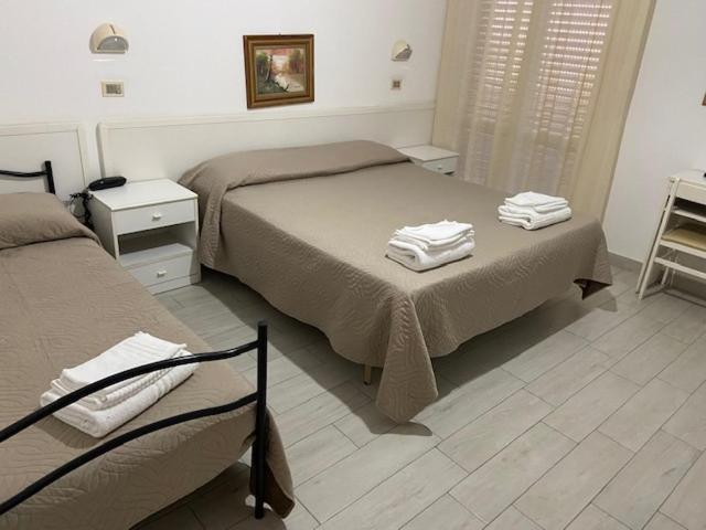 Postel nebo postele na pokoji v ubytování Hotel Primula
