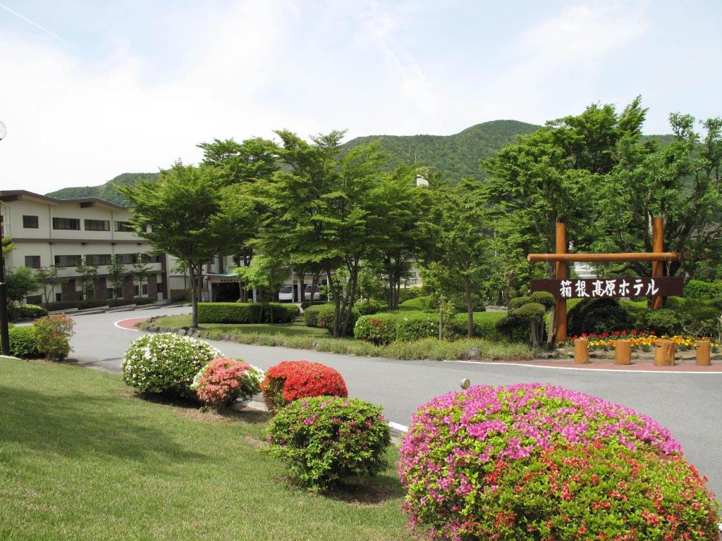 a park with flowers and a sign in the middle at Hakone Kogen Hotel in Hakone