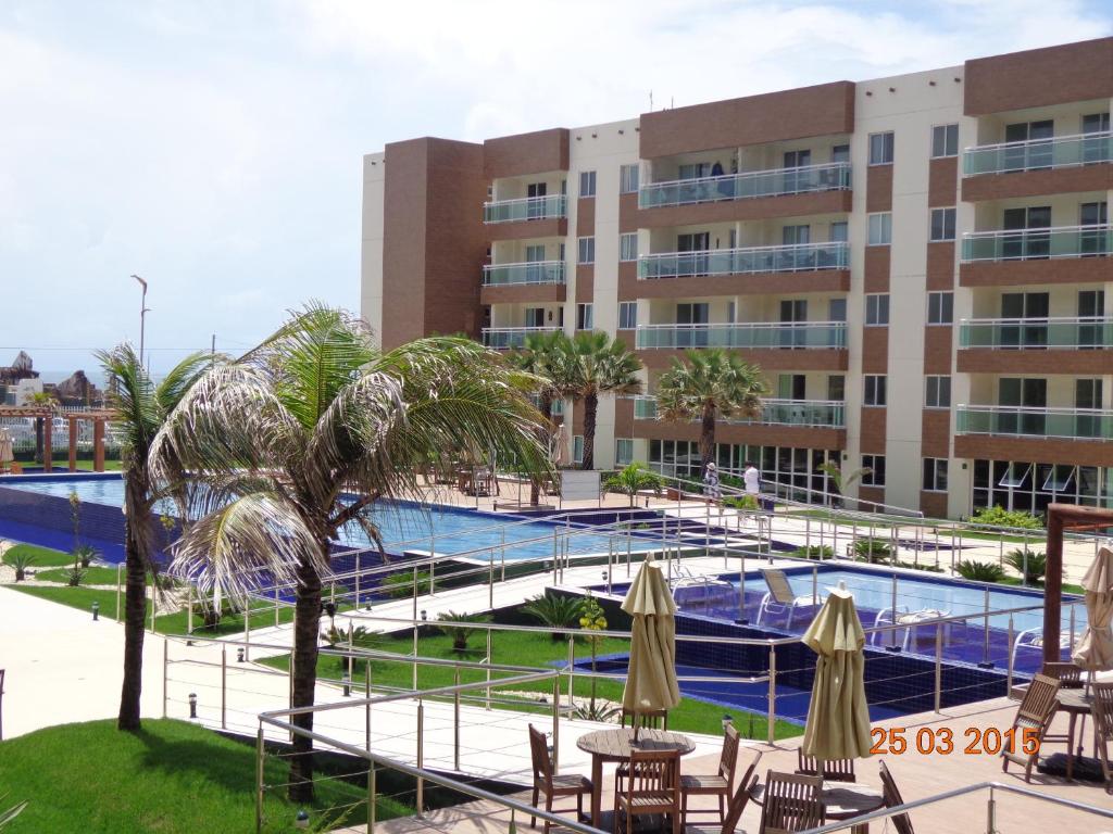 a resort with a swimming pool and a building at VG Fun Residence - Fortaleza Flats in Fortaleza