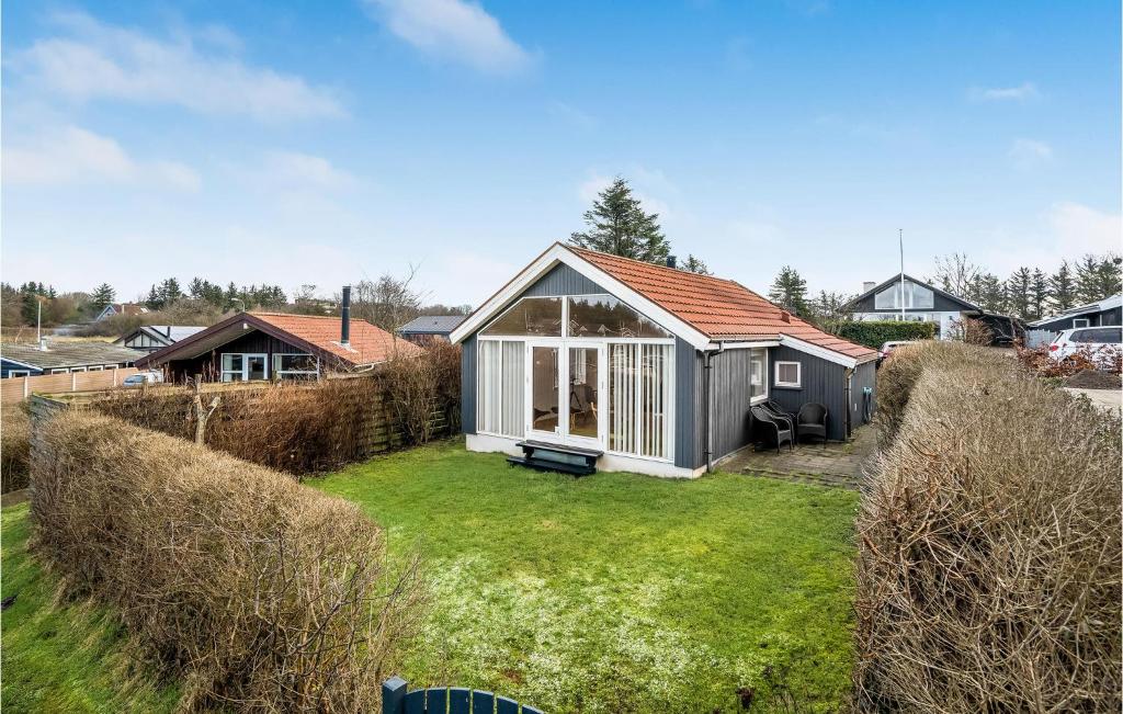 a small house in a yard with a grass yard at 2 Bedroom Nice Home In Esbjerg V in Esbjerg