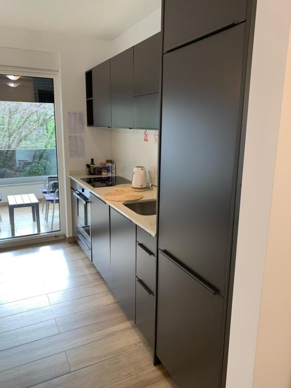 a kitchen with a stainless steel refrigerator and a table at Apartman Nataša in Kostrena