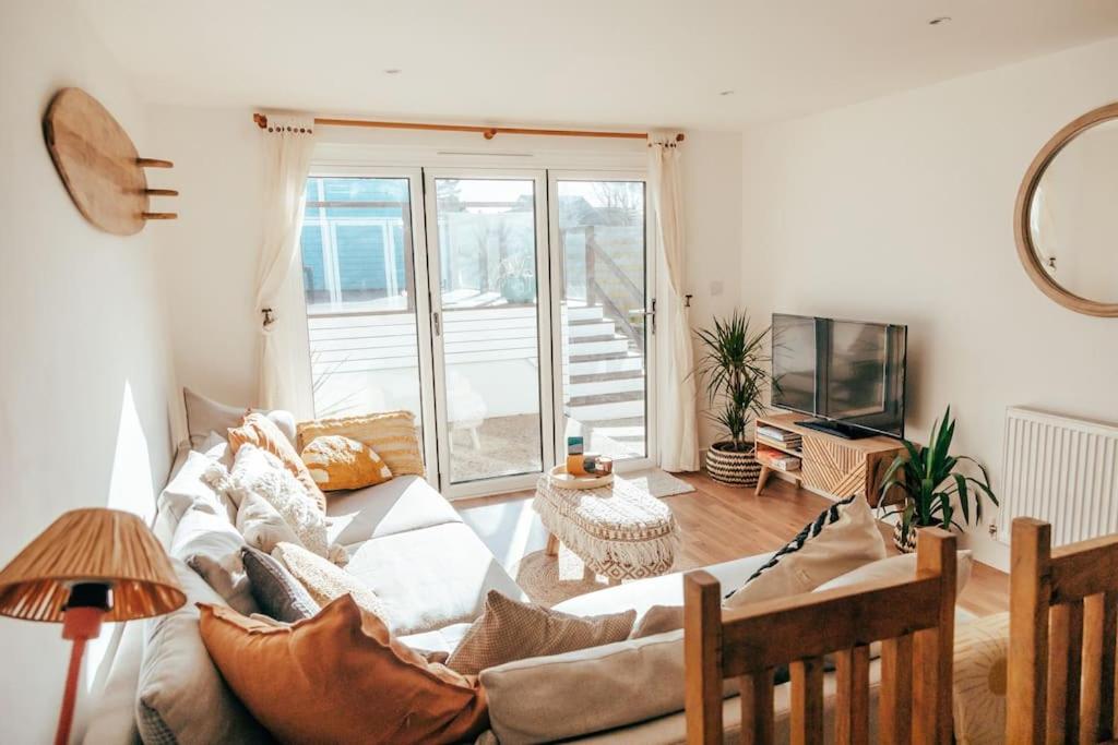 a living room with a couch and a television at The Hideout - Newquay - Fully Stocked Eco Escape in Newquay