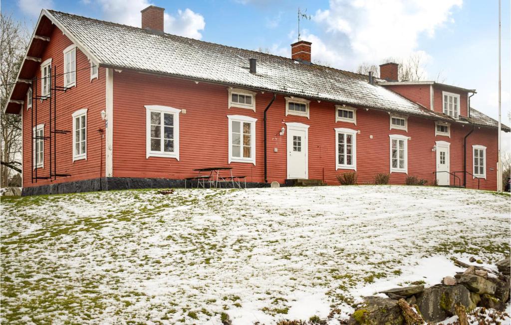 a red house with snow in front of it at 4 Bedroom Lovely Apartment In Orrefors in Orrefors