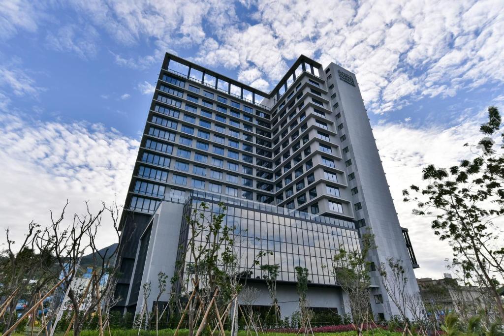 a tall white building with a lot of windows at Four Points by Sheraton Taipei Bali in Bali