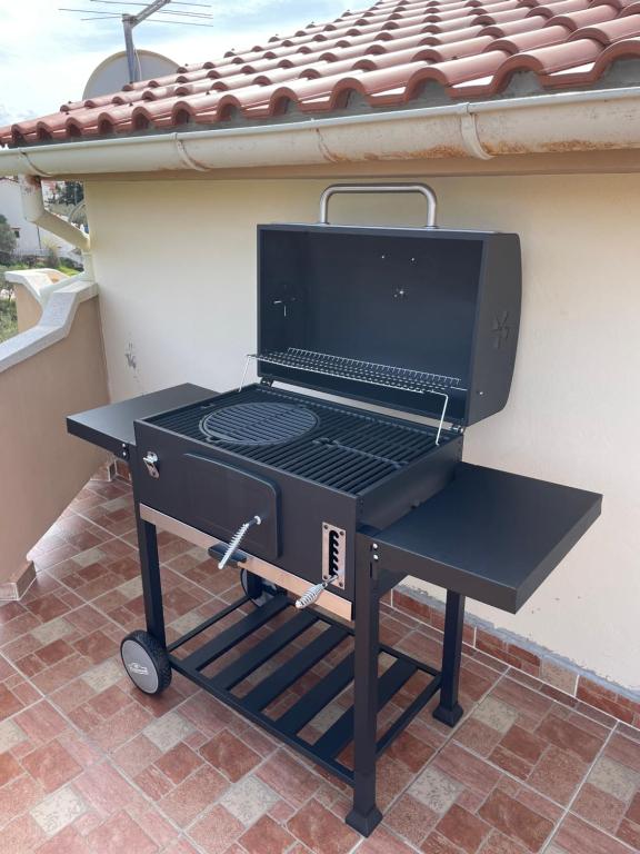 a bbq grill sitting on a patio at Penthouse Damjan in Rab