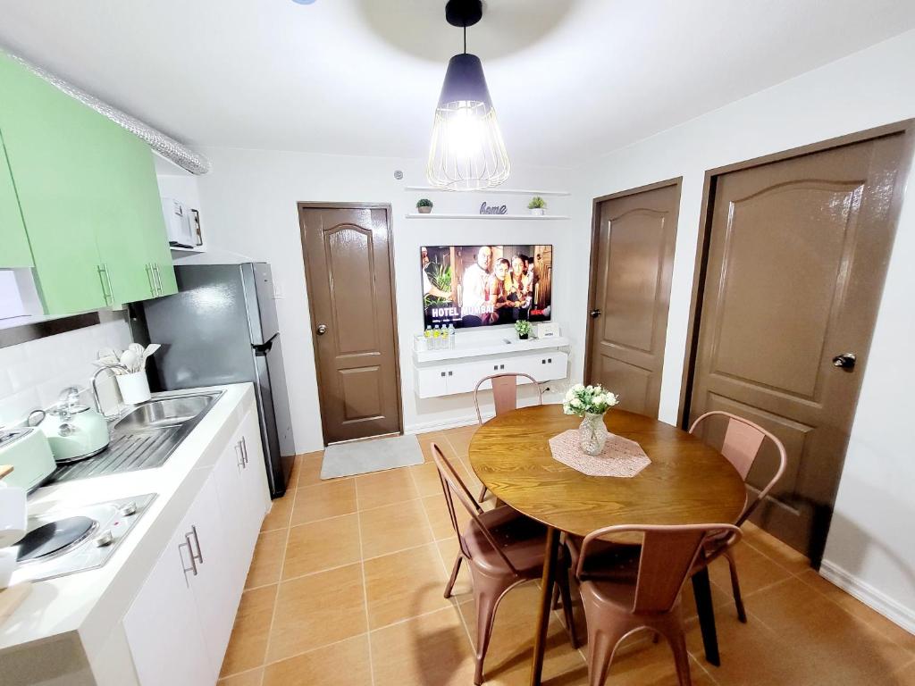 a kitchen with a table and chairs and a television at Steff's Condo 2622 at One Oasis in Cagayan de Oro