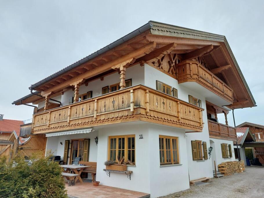 a house with a wooden balcony on top of it at Ferienlodge Karwendelblick in Krün
