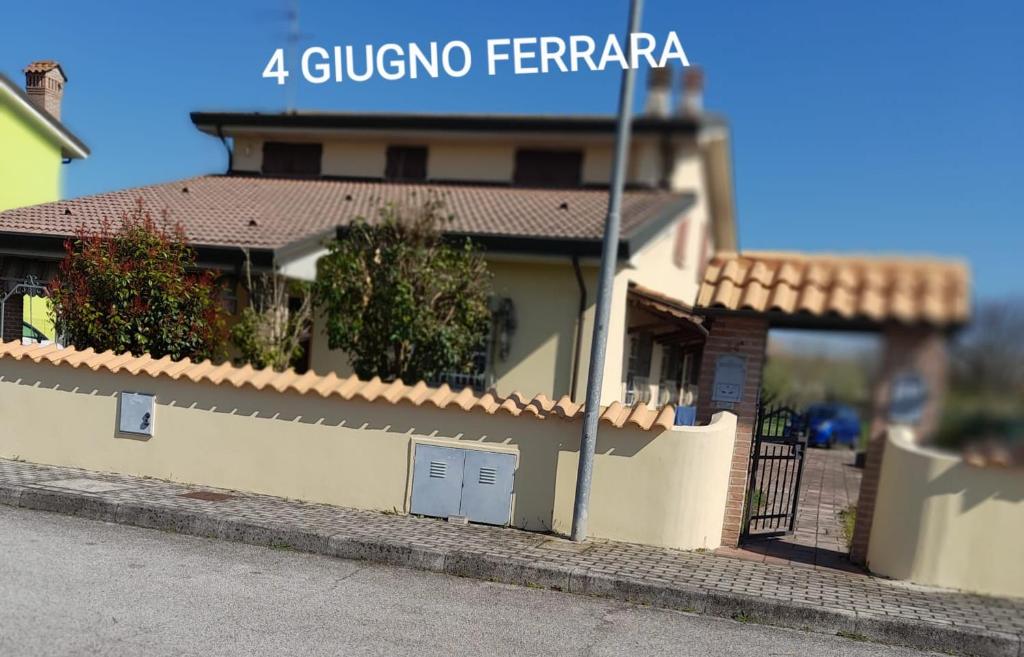 a house with a fence in front of it at 4 giugno Ferrara in Ferrara