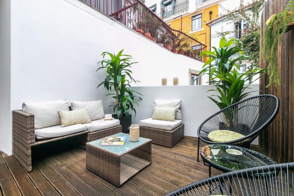 a patio with chairs and a couch and a table at Gonzalos's Guest Apartments - Alfama Terrace in Lisbon