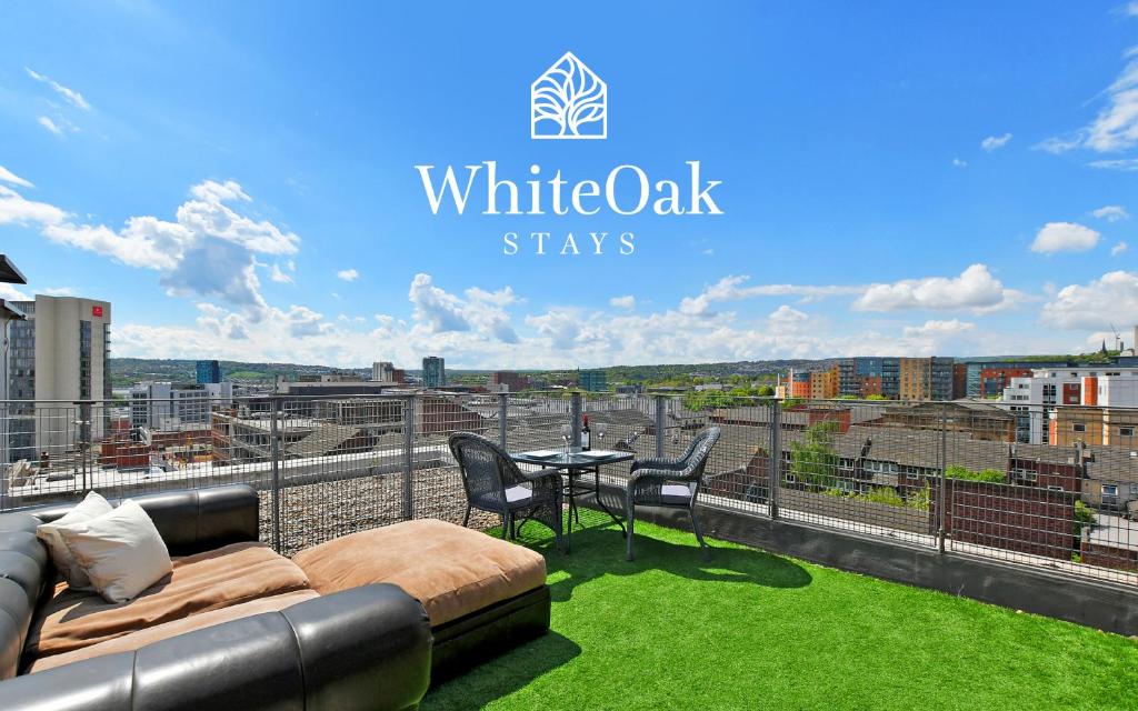 a balcony with a couch and chairs and a table at Sheffield Penthouse with Rooftop Terrace & FREE Parking in Sheffield
