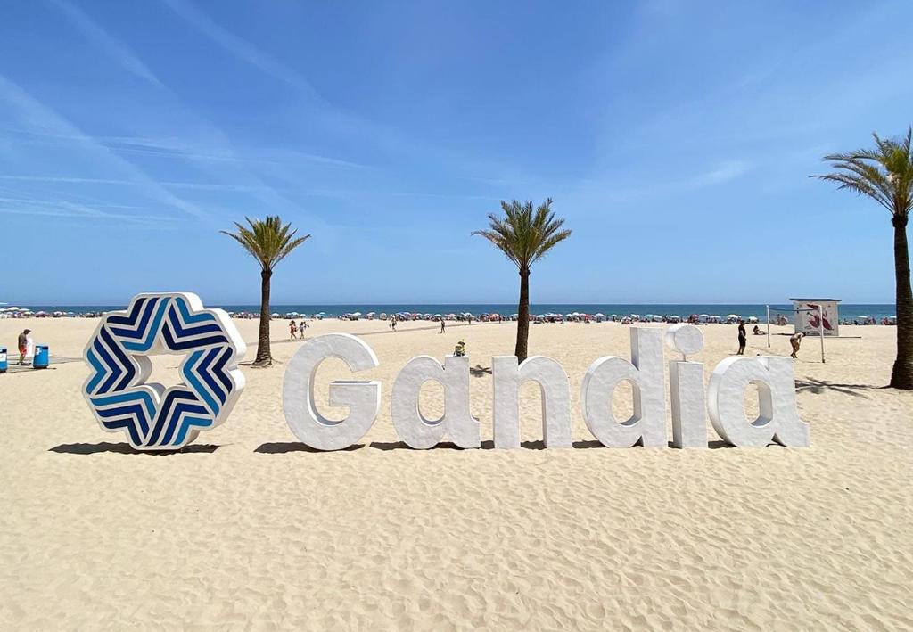 a sign that says gamedico on a beach at Gandia Mallorca 27 in Gandía