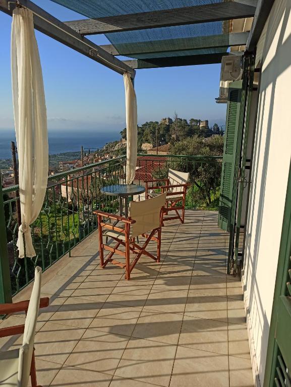 a balcony with a table and chairs and the ocean at Kiparissia Castle & Sea view in Kyparissia