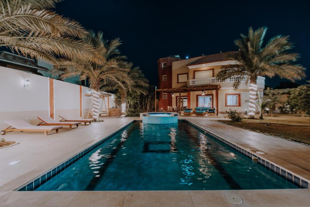 a villa with a swimming pool at night at Luxury private villa with pool in Hurghada