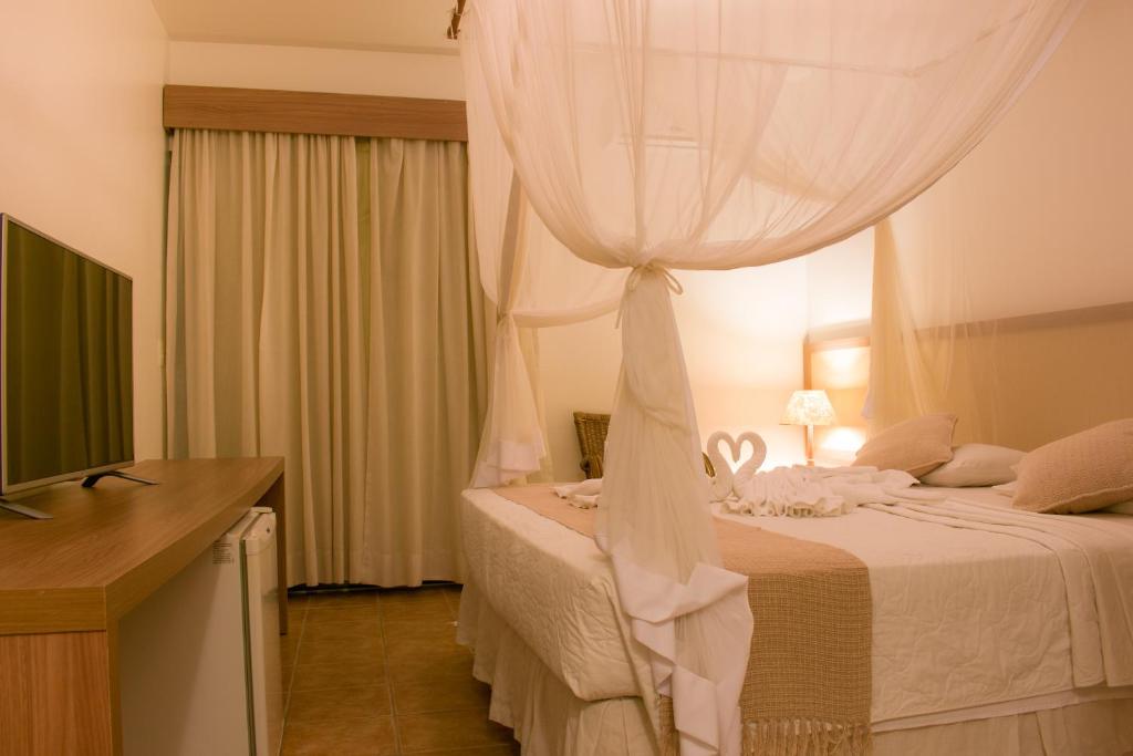 Postel nebo postele na pokoji v ubytování Sarana Praia Hotel