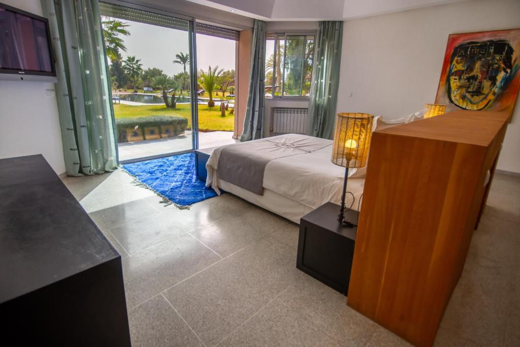 Postel nebo postele na pokoji v ubytování Villa Fima Kech