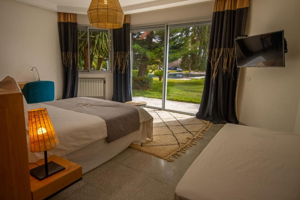 Postel nebo postele na pokoji v ubytování Villa Fima Kech