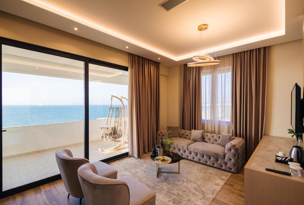 sala de estar con sofá y vistas al océano en Gloria Palace Hotel & SPA, en Golem