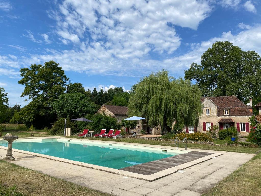 une piscine devant une maison dans l'établissement Sfeervol vakantiehuis op landgoed aan de Dordogne, à Prudhomat