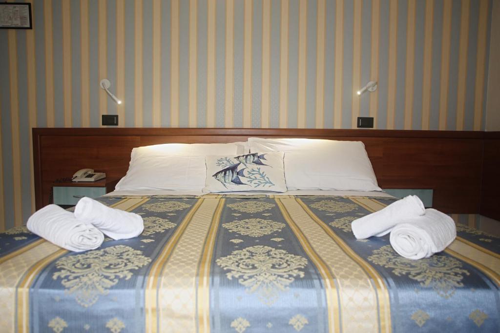 Postel nebo postele na pokoji v ubytování Hotel Dear Rimini
