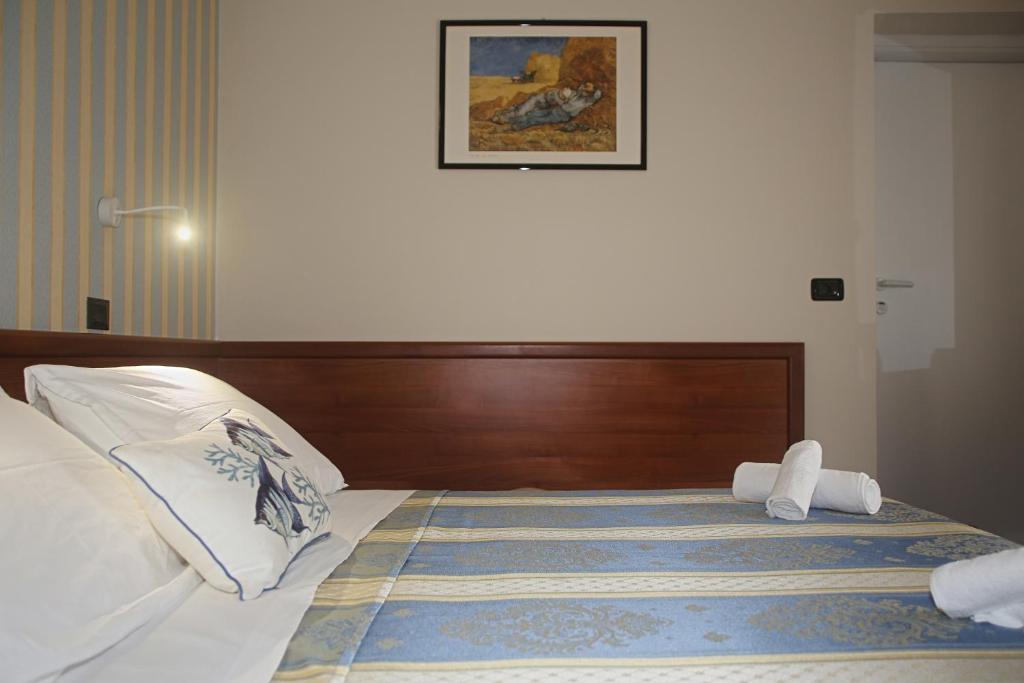 Postel nebo postele na pokoji v ubytování Hotel Dear Rimini