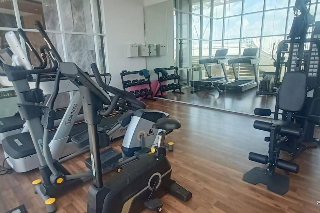 a gym with treadmills and elliptical machines at Batam Luxurious, Breezy 1 bedroom! in Nongsa