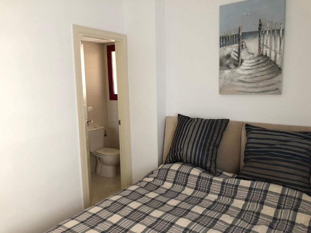 a bedroom with a bed and a picture on the wall at Amatista 11 a in Calpe