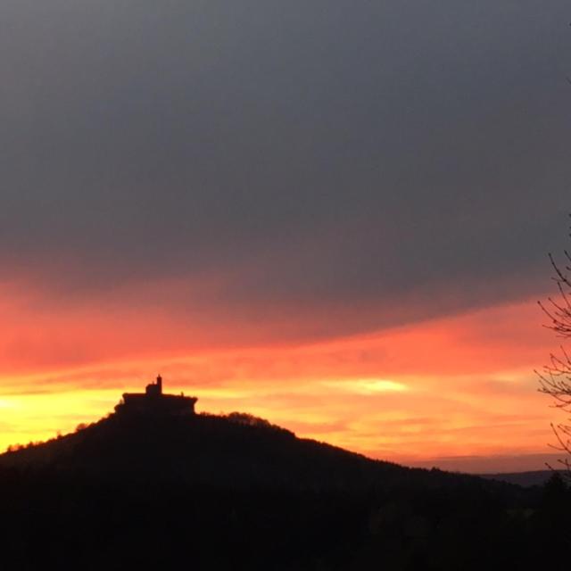 a silhouette of a house on a hill at sunset at Gite Les Melezes in Dabo