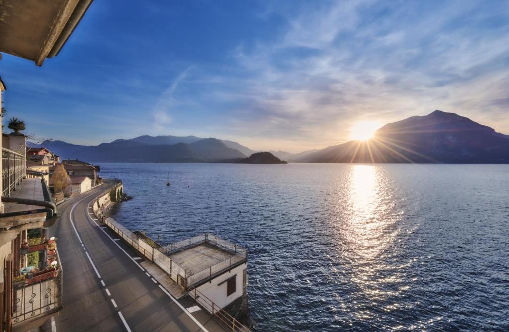 a view of a body of water with the sun setting at Margherita House in Varenna