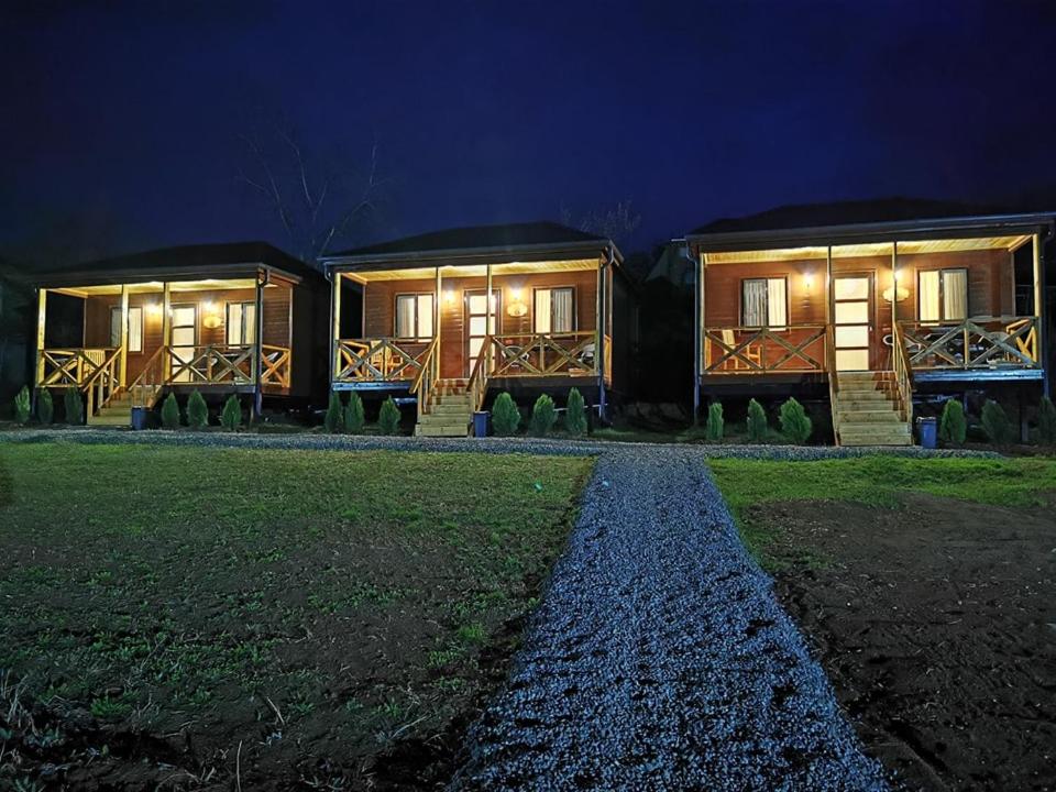 a couple of houses at night with lights at Chateau Ateni Cottages in Gori