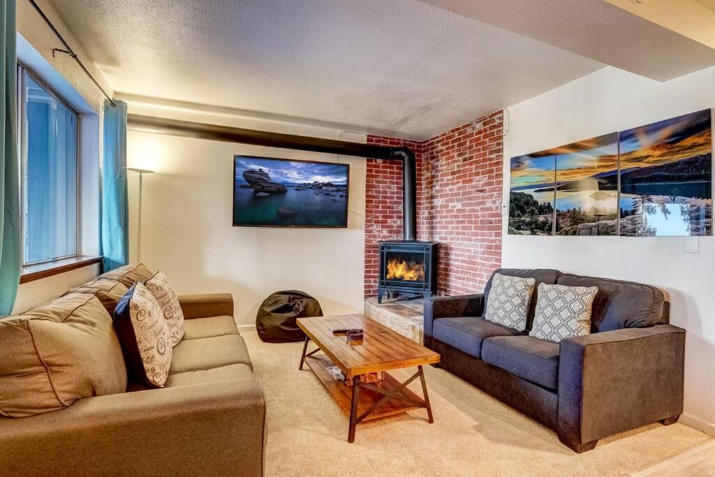 a living room with a couch and a fireplace at Spacious Lakeview Heavenly Mountain Escape! in Stateline