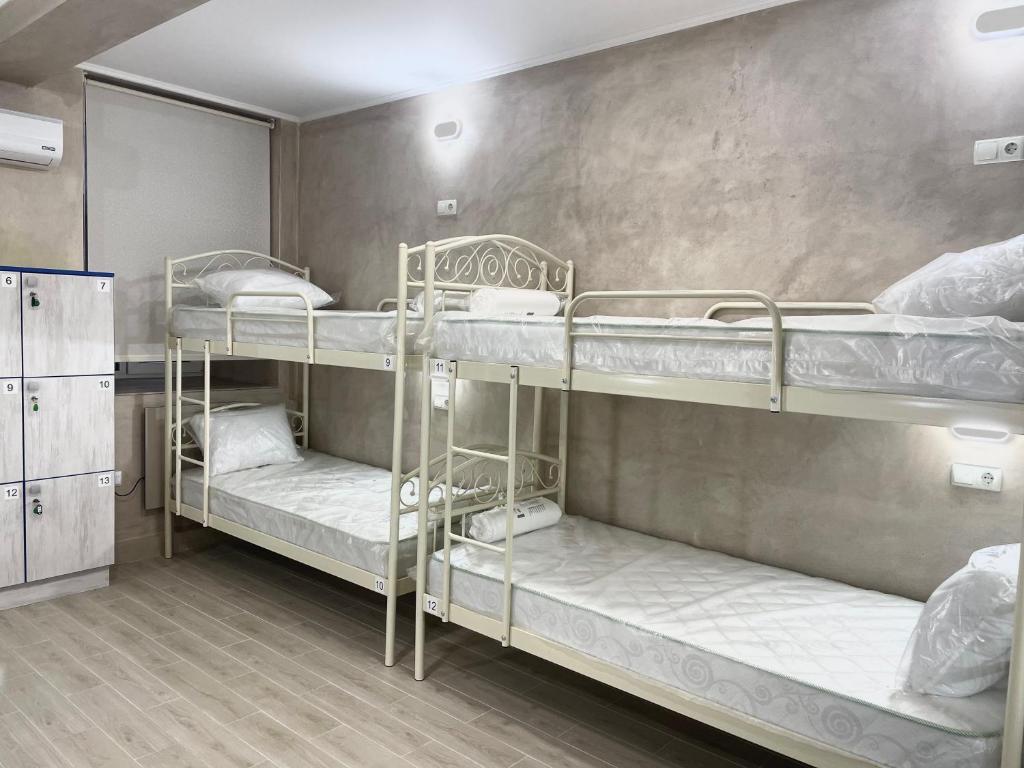 a room with three bunk beds in it at Hostel GARDEN St in Odesa