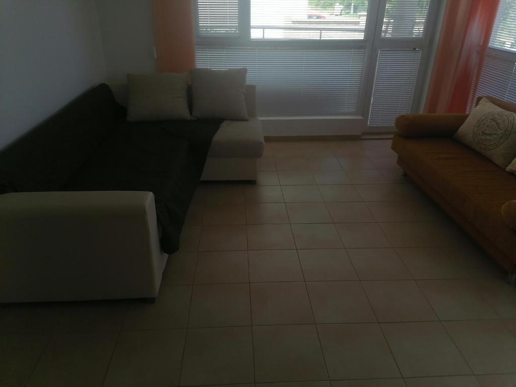 a living room with two couches and a tile floor at Tedi in Kranevo