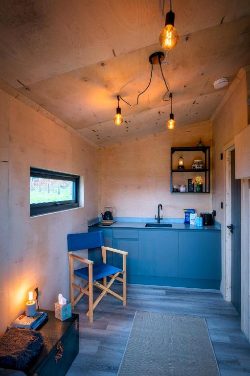 a kitchen with a sink and a table in a room at Luxury Glamping Cabin with Outdoor Bath on Cornish Flower Farm in Truro