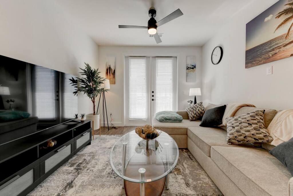 a living room with a couch and a glass table at Classic Unit At Downtown Austin Texas in Austin