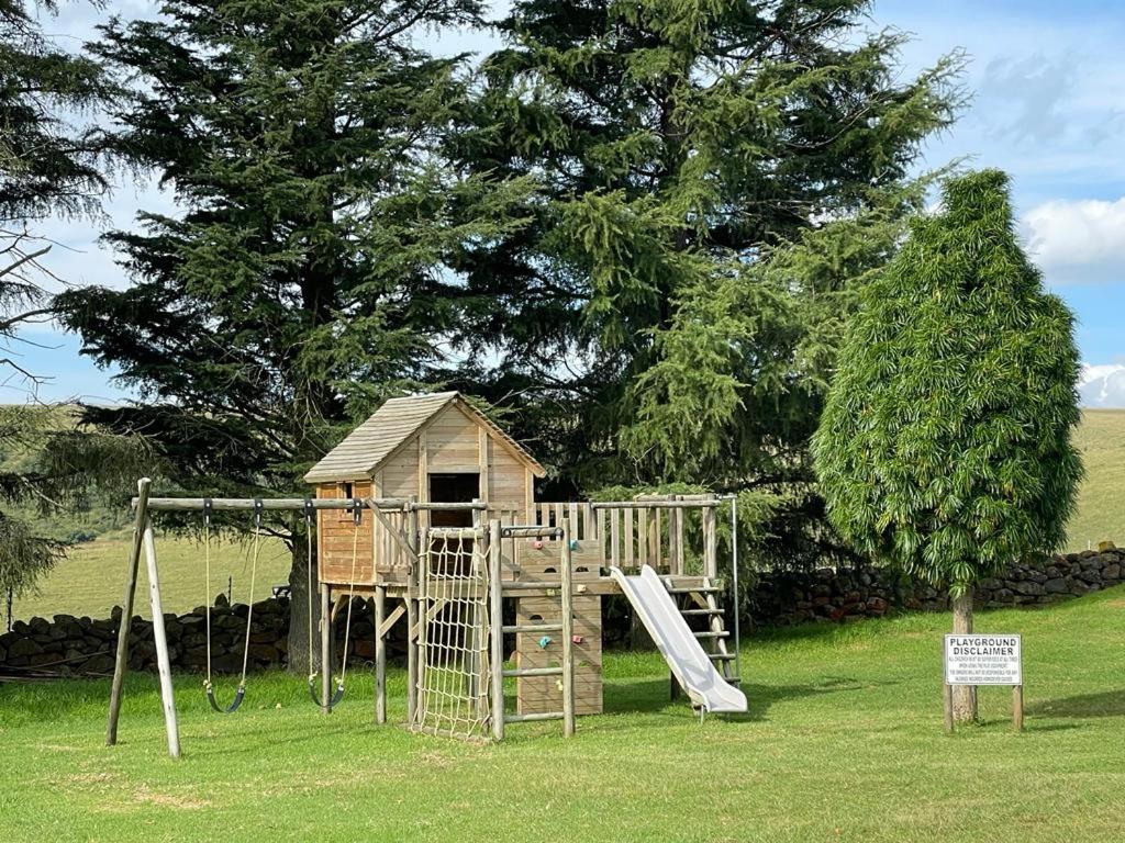 a playground with a house and a slide at Kerriston Guest House in Mooirivier