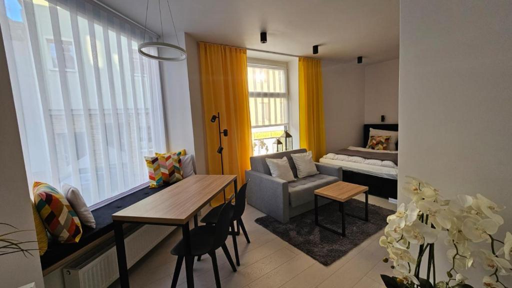 a living room with a couch and a table and a couch at Apartament na Wodnej in Głogówek
