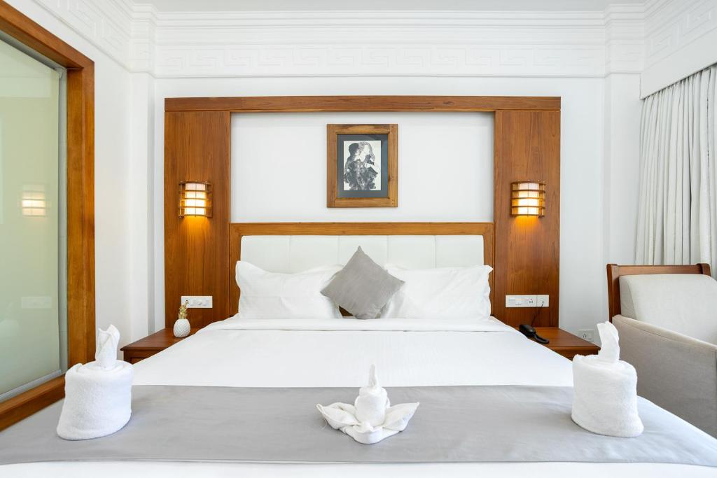 Postel nebo postele na pokoji v ubytování HOTEL WHITE HOUSE, Munnar