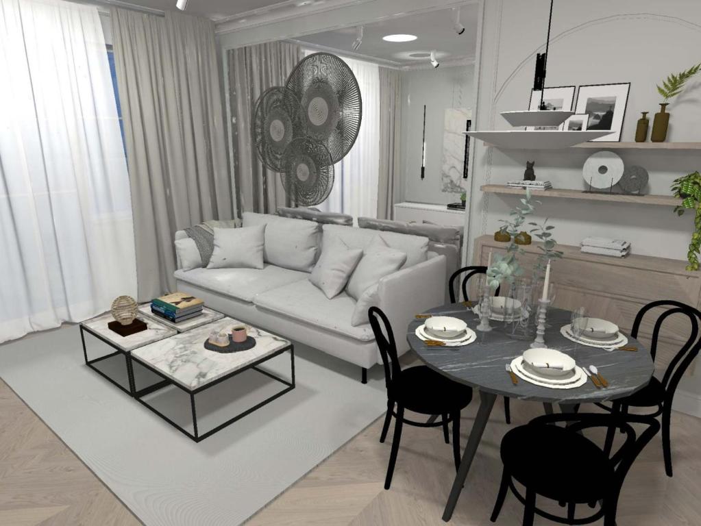 a living room with a white couch and a table at Apartament Lux Sopot Monte Cassino in Sopot