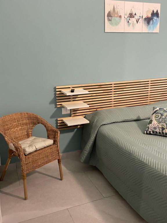 a bedroom with a bed with a chair and a desk at Approdo Felice in Formia