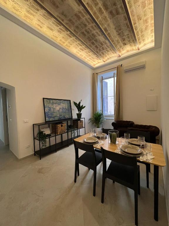 a living room with a table and a couch at Al Vicolo Holiday House in Terracina