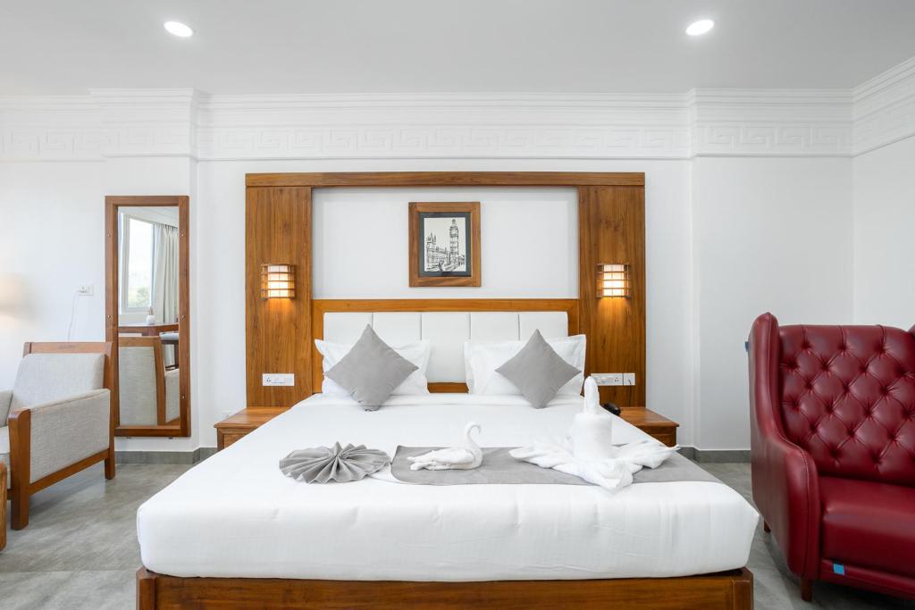 Postel nebo postele na pokoji v ubytování HOTEL WHITE HOUSE, Munnar