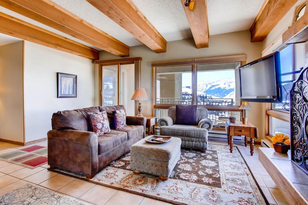 a living room with a couch and a tv at 2 Br With Open Floor Plan & Updated Kitchen Condo in Crested Butte