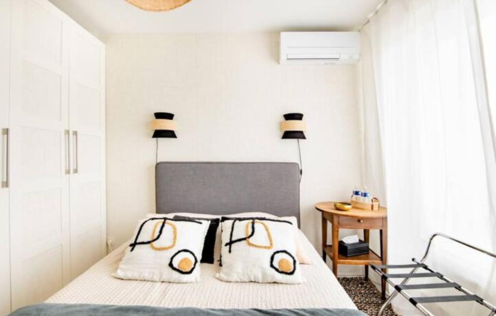 a bedroom with a bed with two pillows at Chambres Élégance - Parc Bordelais in Bordeaux
