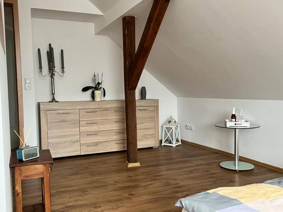 a bedroom with a bed and a dresser in a room at Ferienwohnung Berghaus in Warendorf