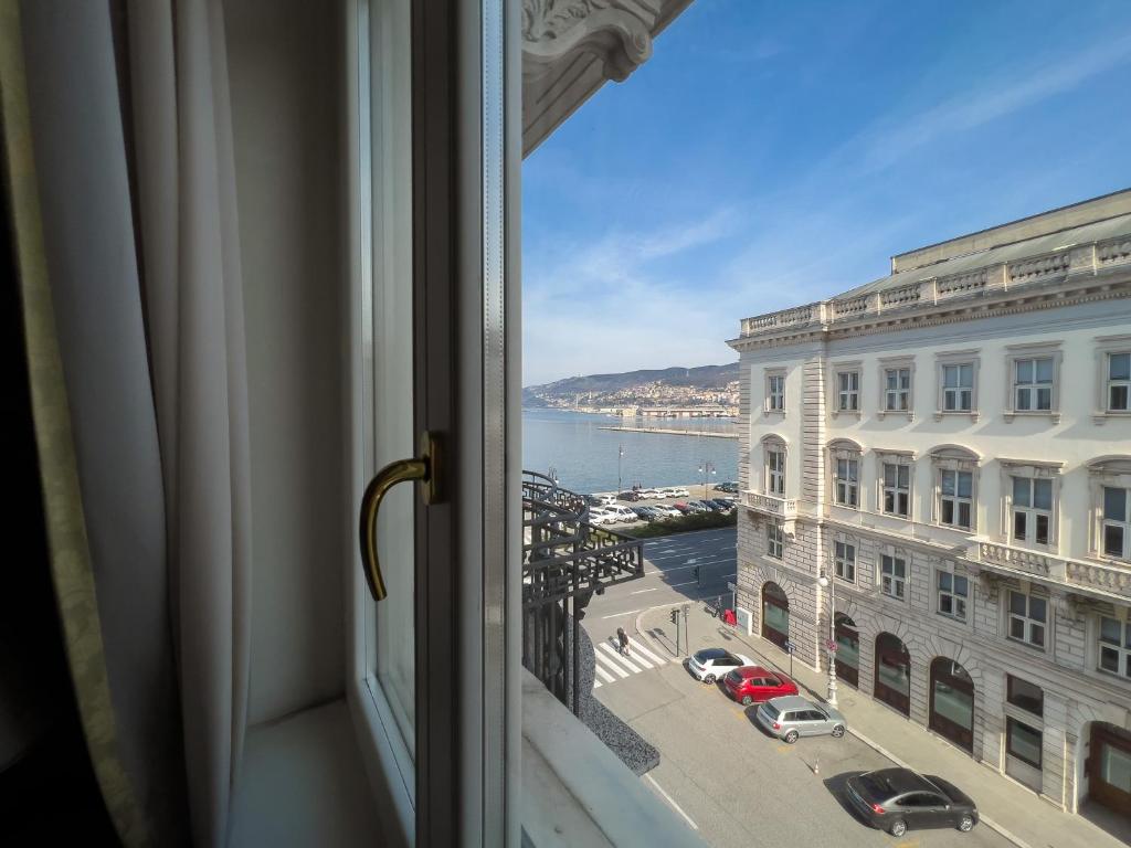 a window with a view of a street and buildings at Trieste Luca's Home in Trieste