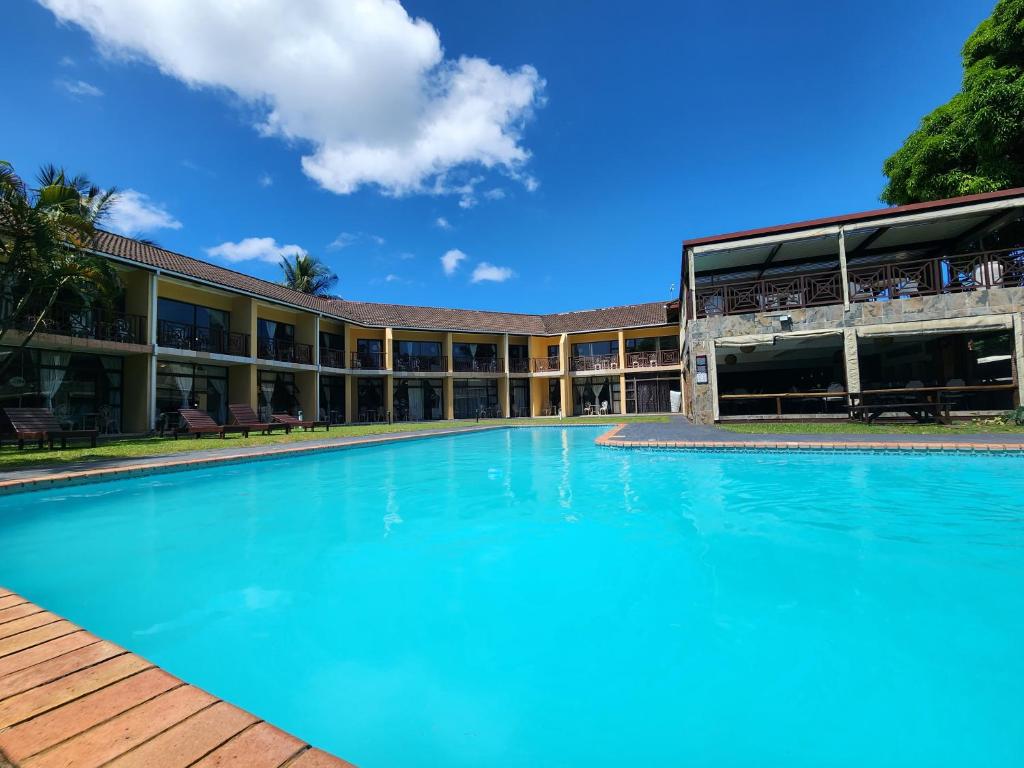 a large swimming pool in front of a building at Elephant Lake Hotel in St Lucia