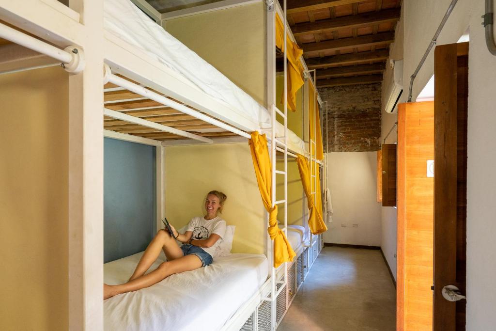 a person sitting on a bed in a bunk bed at Casa Tunido in Santa Marta